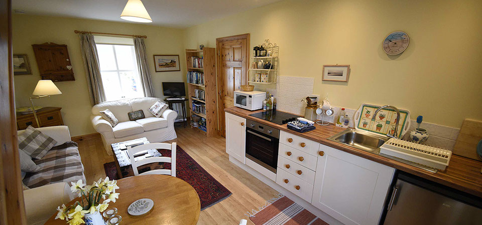 Half of Three self catering accommodation contains a comfortable seating area and modern kitchen