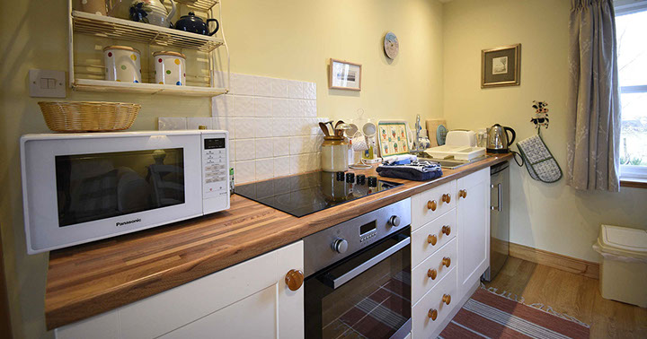 Half of Three self catering accommodation contains a modern kitchen with oven hob and fridge freezer